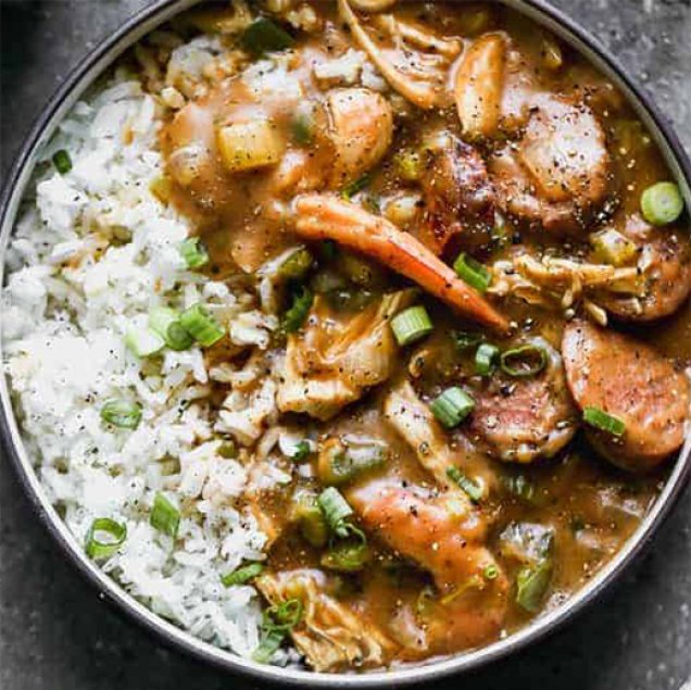 This Authentic New Orleans Gumbo is made with a dark roux, vegetables, chicken, sausage, and shrimp, and served over rice.