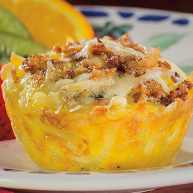 Eggs, sausage, onion, and cheese are baked in hash brown potato muffins for a delicious breakfast.